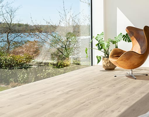 bedroom with grey vinyl floor and view on nature